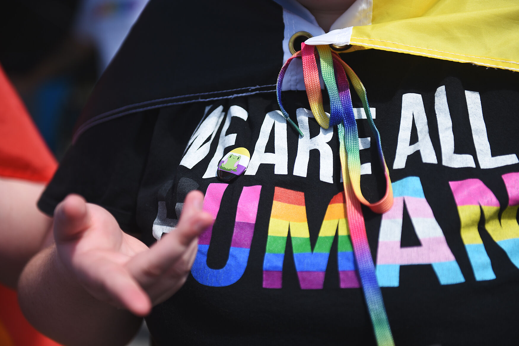 A PrideFest attendee wears a t-shirt reading “We are all humans”